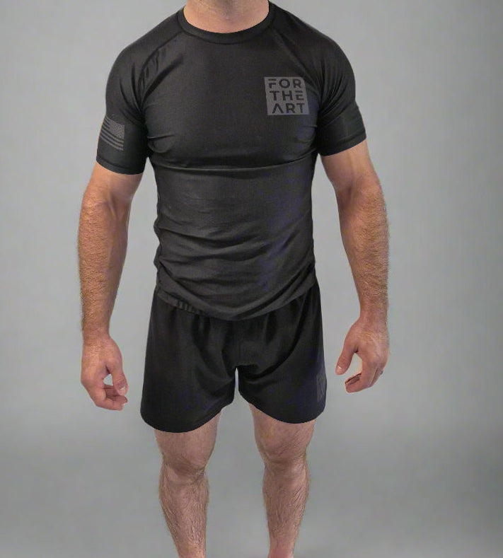Man wearing a black athletic outfit with a logo on a white background
