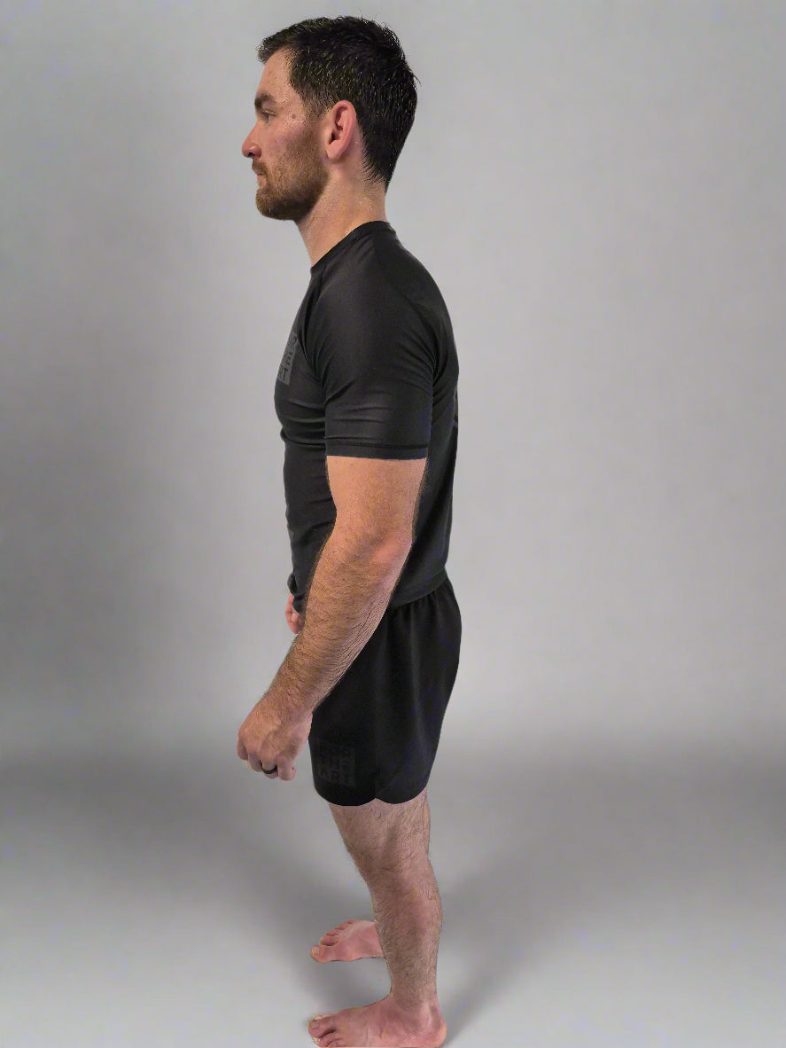Man standing with a neutral expression against a plain white background