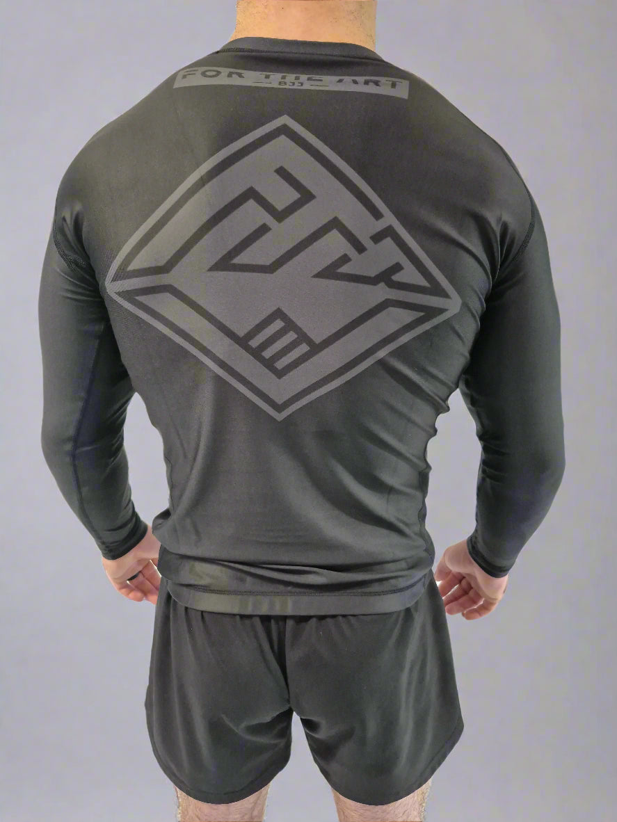 Person wearing a gray athletic outfit with a logo on the back against a white background